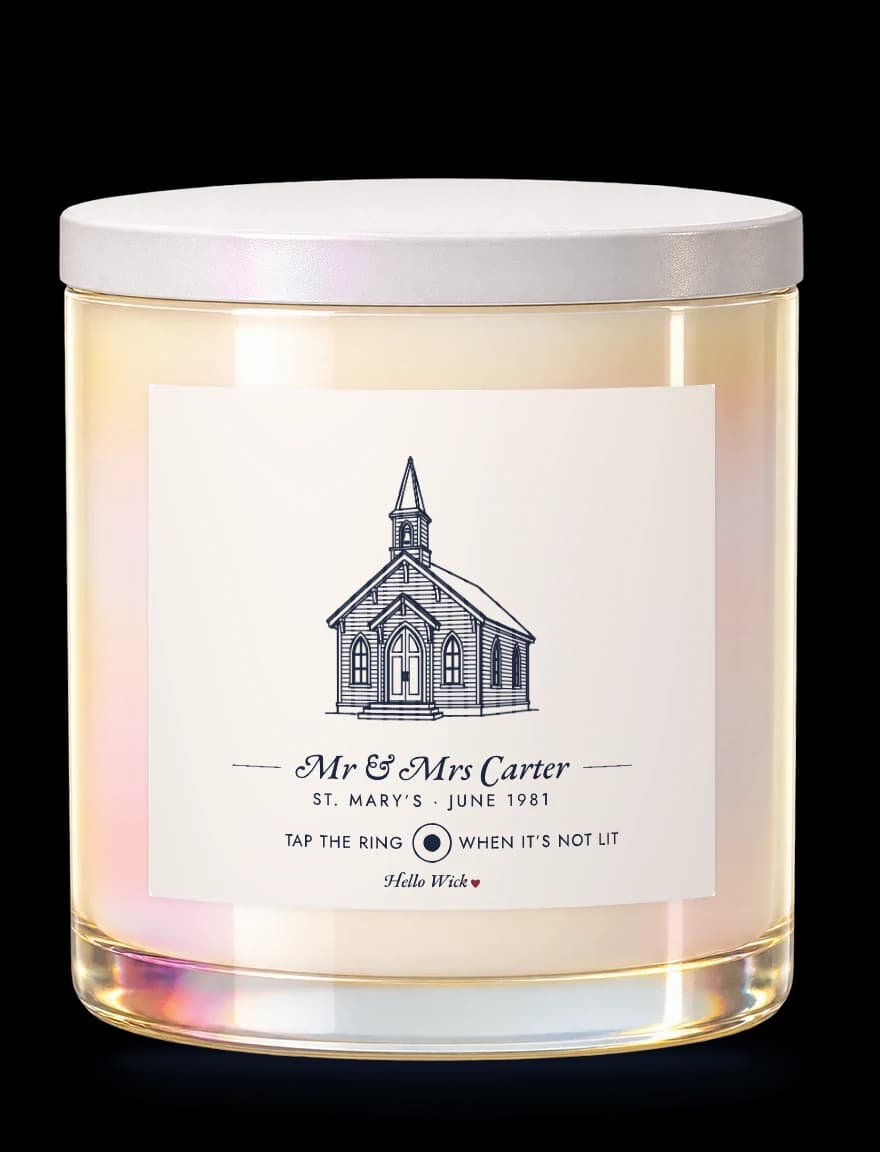 A Hello Wick candle labelled Mr & Mrs Carter, with a drawing of a church