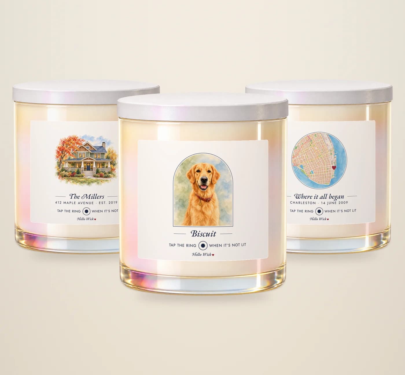 Three Hello Wick candles: Biscuit with a watercolor of the dog in an arch, The Millers with a watercolor of their house, and Where it all began with a round watercolor map